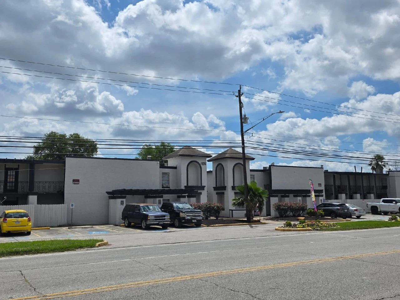 Repositioned multifamily property — clean white exterior with dark accents