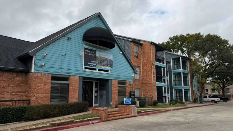 Three-story building after balcony and siding refresh