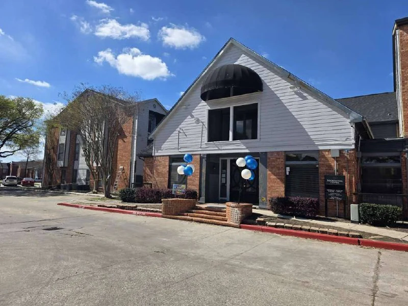 Canfield leasing office after — clean white siding and refreshed entry
