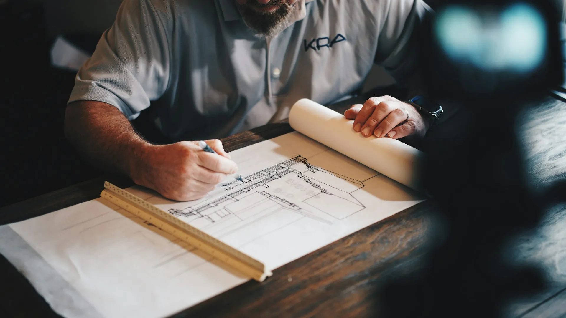 Architect drafting blueprints during pre-construction planning